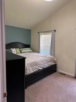 a bedroom with a bed and a window at Home Away From Home in Ridley Park