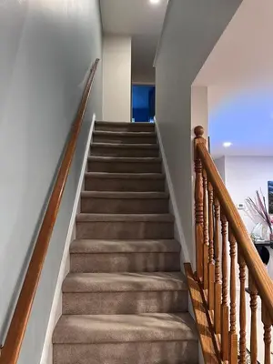 a staircase in a home with wooden railings at Home Away From Home in Ridley Park