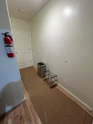 an empty room with a fire extinguisher and a door at Comfortstayrus in Orange