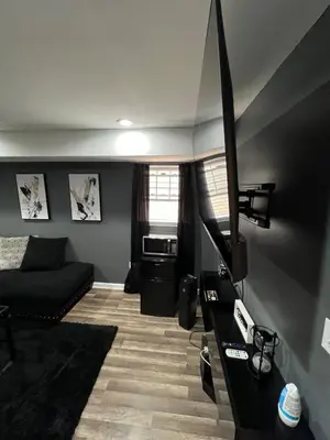 a living room with a couch and a television at Comfortstayrus in Orange