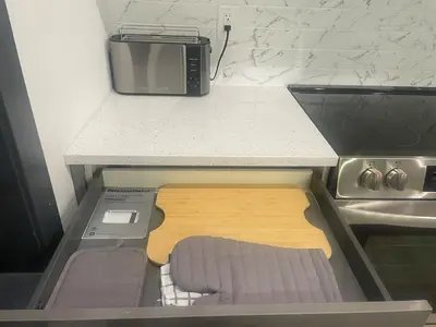 a small kitchen with a counter and a microwave at Luxurious and Spacious Apt with Parking 20 min to NYC in West New York