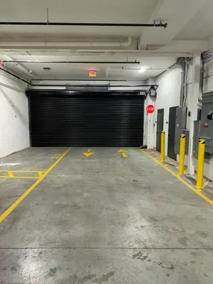 an empty parking garage with a large garage door at Luxurious and Spacious Apt with Parking 20 min to NYC in West New York