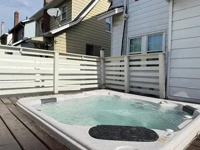 a hot tub in the backyard of a house at Best RV-Camper To Visit NYC-Hot Tub-Free Parking in Hillside