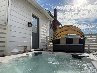 a hot tub on a patio next to a house at Best RV-Camper To Visit NYC-Hot Tub-Free Parking in Hillside