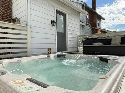 a hot tub sitting on the side of a house at Best RV-Camper To Visit NYC-Hot Tub-Free Parking in Hillside