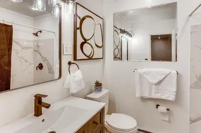 a white bathroom with a sink and a toilet at Family Home on Greenbelt, 4 Mi to Dtwn Harrisburg! in Harrisburg