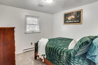 a bedroom with a bed and a picture on the wall at Family Home on Greenbelt, 4 Mi to Dtwn Harrisburg! in Harrisburg