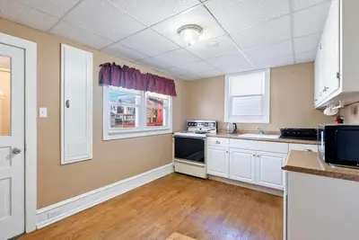 a kitchen with white cabinets and a black stove at The Serenity Manor in Chester