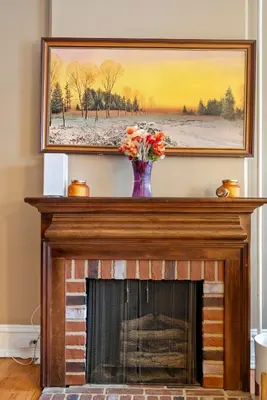 a fireplace with a vase of flowers on top of it at The Serenity Manor in Chester