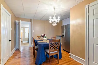 a dining room with a blue table and chairs at The Serenity Manor in Chester