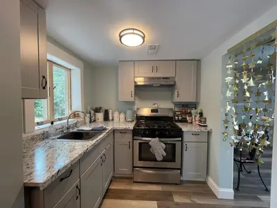 a kitchen with a stove and a sink at Cheerful two bedroom bungalow near Mountain Creek in West Milford
