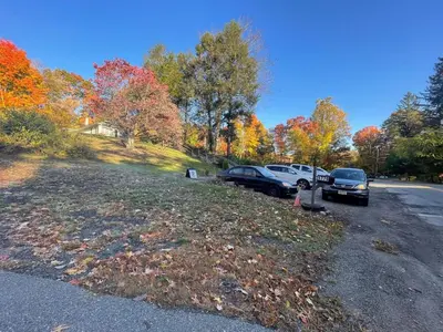 a parking lot with cars parked on the side of a road at Cheerful two bedroom bungalow near Mountain Creek in West Milford