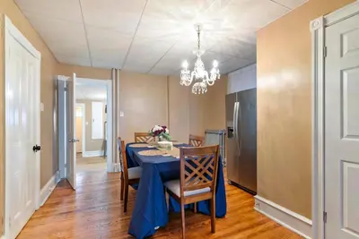a dining room with a blue table and chairs at Candlelight Chamber - Private Room with Shared Space in Chester