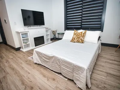 a bedroom with a large bed with a tv on it at Excellent Location-20 Minutes to NYC-Free Parking in West New York
