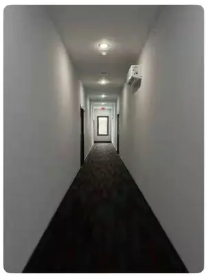 an empty hallway with a door in a building at Excellent Location-20 Minutes to NYC-Free Parking in West New York