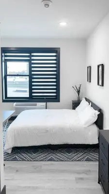 a bedroom with a white bed and a window at City excitement -Studio 20 Minutes to (42st) NYC in West New York