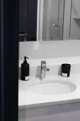 a bathroom sink with a soap dispenser and a mirror at City excitement -Studio 20 Minutes to (42st) NYC in West New York