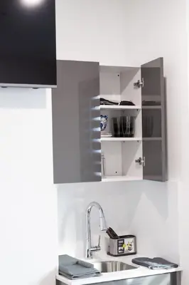 a kitchen with stainless steel cabinets and a sink at City excitement -Studio 20 Minutes to (42st) NYC in West New York