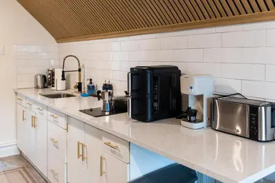 a kitchen counter with a coffee maker and a microwave at Bright, Cozy, and Peaceful Two Bedroom Apt Near NYC in North Bergen