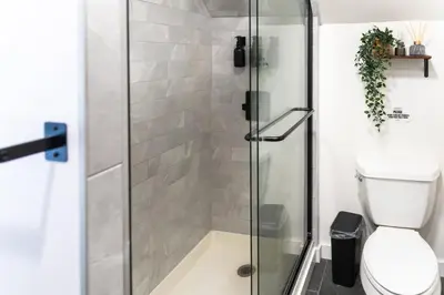 a shower stall in a bathroom with a toilet at Bright, Cozy, and Peaceful Two Bedroom Apt Near NYC in North Bergen