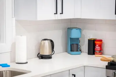 a kitchen counter with a coffeemaker and a coffee maker at City Adventure-Quick NYC Access-2BR-Free Parking in West New York