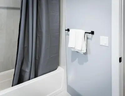 a bathroom with a shower curtain and a bath tub at City Adventure-Quick NYC Access-2BR-Free Parking in West New York