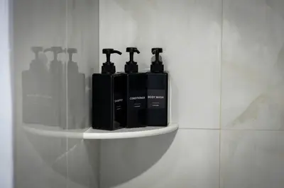a shelf with two bottles on a wall at City Adventure-Quick NYC Access-2BR-Free Parking in West New York