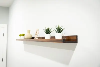 a wooden shelf with plants on a white wall at City Adventure-Quick NYC Access-2BR-Free Parking in West New York
