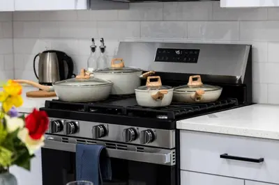 a stove with three pots on top of it at Quick NYC Access with Free Parking Two Bedrooms Near NYC in West New York