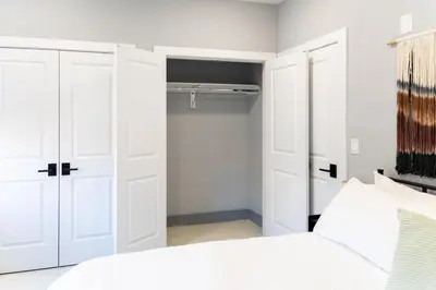 a bedroom with white cabinets and a bed at Quick NYC Access with Free Parking Two Bedrooms Near NYC in West New York