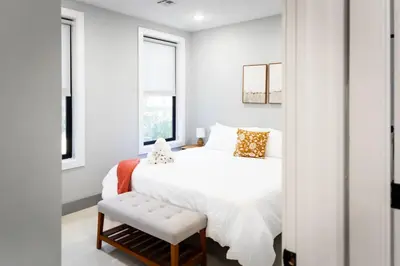 a bedroom with a white bed and a window at Bright Apartment with Free Parking Near NYC in West New York