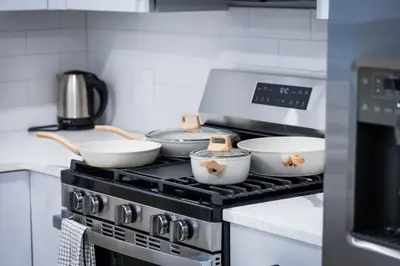 a kitchen with a stove with bowls on it at Bright Apartment with Free Parking Near NYC in West New York
