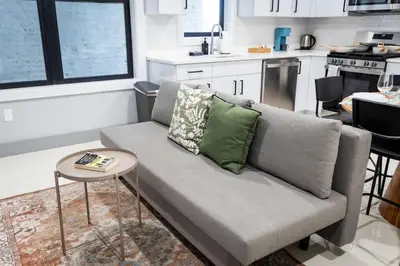 a living room with a couch and a table at Bright Apartment with Free Parking Near NYC in West New York