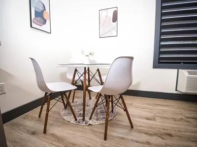 a dining room with a table and two chairs at Prime Location with Free Parking Near NYC in West New York