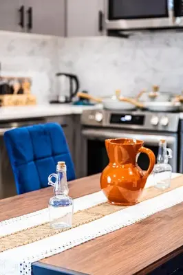 an orange vase sitting on a table in a kitchen at Two Bedrooms with Free Parking Near NYC in West New York