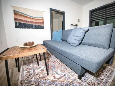 a living room with a couch and a table at Explore New York City-20 Minutes Away With Parking in West New York