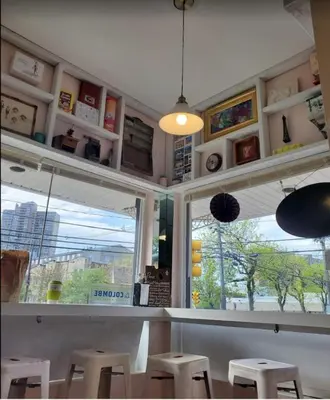 a kitchen with a bar with stools and a window at Explore New York City-20 Minutes Away With Parking in West New York