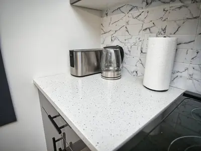 a counter with two toasters and a roll of paper towels at Great Location-20 Mins to NYC-Free Indoor Parking in West New York