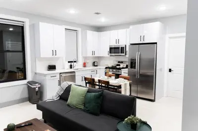 a living room with a couch and a kitchen at 2 Bedroom Apt-City Adventure-Free Parking on Site in West New York