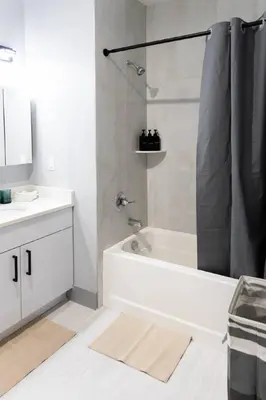 a white bathroom with a tub and a sink at 2 Bedroom Apt-City Adventure-Free Parking on Site in West New York
