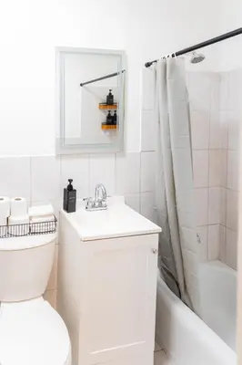 a bathroom with a toilet and a sink and a shower at Spacious 2-Bedroom Apartment NYC-10 mins away in Union City