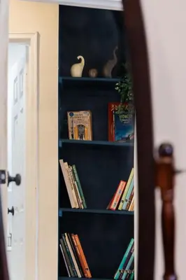 a book shelf filled with books next to a door at Spacious 2-Bedroom Apartment NYC-10 mins away in Union City
