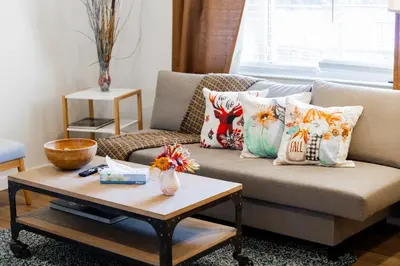 a living room with a couch with pillows and a coffee table at Spacious 2-Bedroom Apartment NYC-10 mins away in Union City