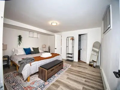 a bedroom with a bed and a desk and a ladder at Cozy Apt With King Size Bed- Only 5 Miles to NYC in North Bergen