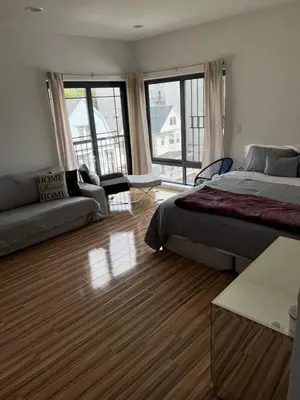 a bedroom with a bed and a couch and a living room at Private Suite Hudson River View in Union City