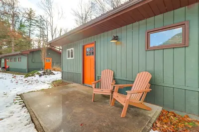 two chairs and a table outside of a green house at Deluxe Cabin D at Elk Creek Escape! Pets Welcome in Hillsgrove
