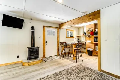 a living room with a fireplace and a stove at Deluxe Cabin D at Elk Creek Escape! Pets Welcome in Hillsgrove