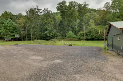 a parking lot with a picnic table next to a building at Deluxe Cabin D at Elk Creek Escape! Pets Welcome in Hillsgrove