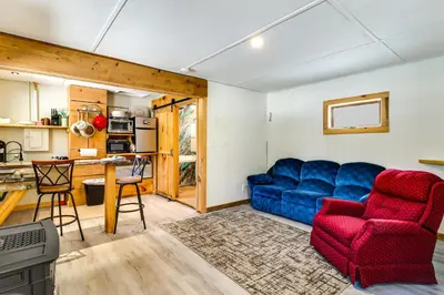 a living room with a blue couch and a red chair at Deluxe Cabin D at Elk Creek Escape! Pets Welcome in Hillsgrove