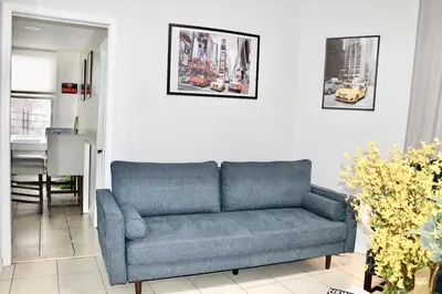 a blue couch sitting in a living room at Private room B in West NYNJ 12mints from NYCity Times Square in West New York